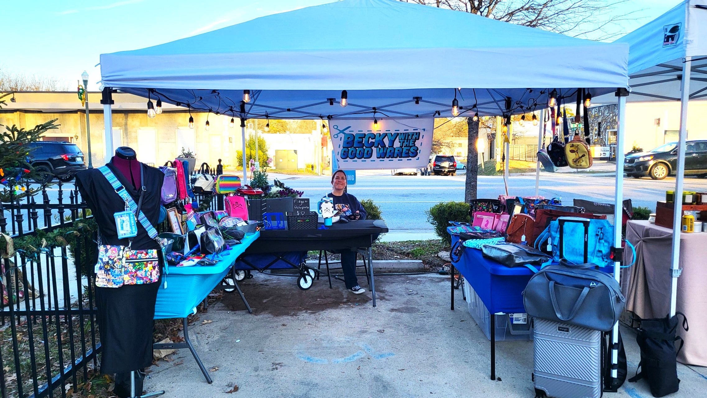 Becky set up at a booth, selling her purses.